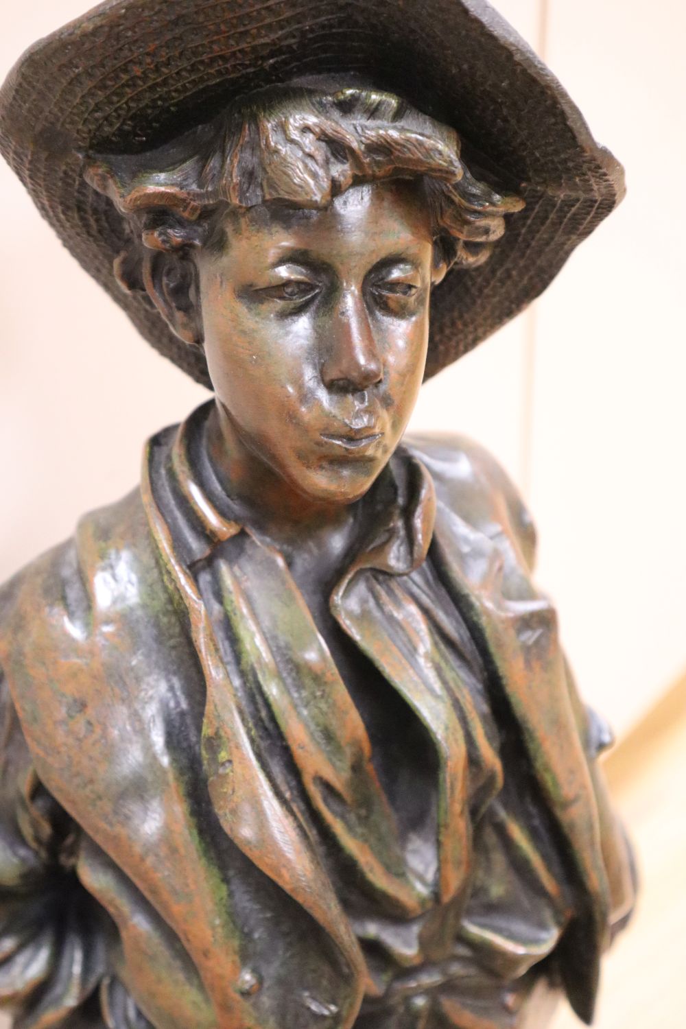 After H. Wiesse. A large patinated spelter figure of a fruit picker entitled Siffleur signed, total height 74cm